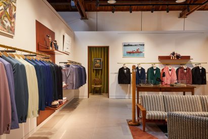Suits displayed in colour order on long brass rails