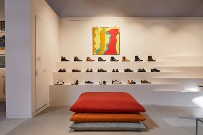 Shoes presented on stepped white ledges that resemble bleacher seating