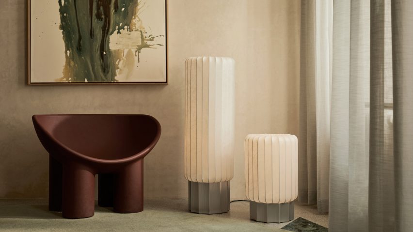 Two off-white lamps beside chair and window