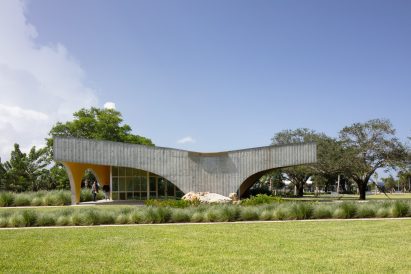 A building with a concrete shell that slopes downwards at the middle