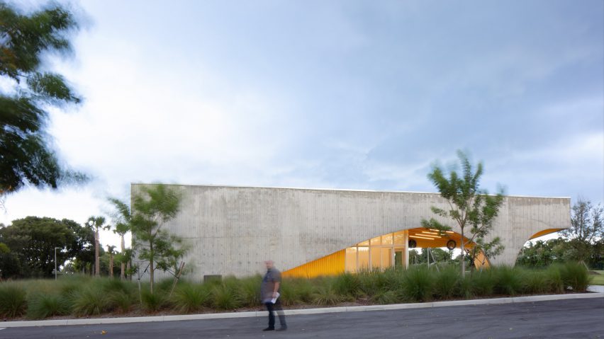 Man in front of concrete field house