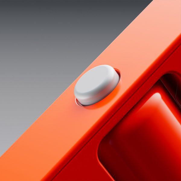 Close-up image of a small grey button on the side of a slim orange device
