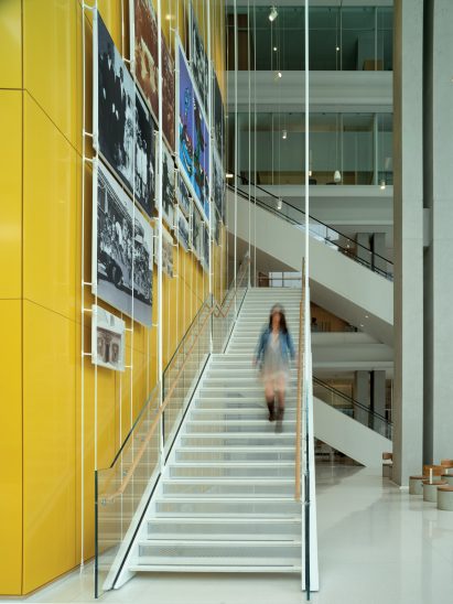 Woman walking down white suspended staircase