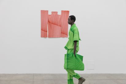 Model wearing all-green outfit from informed by Ronan Bouroullec drawings
