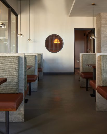 Two rows of booth seating either side of a walkway