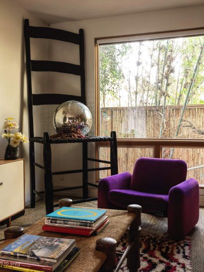 Den with a purple armchair and an oversized chair with a disco ball on its seat