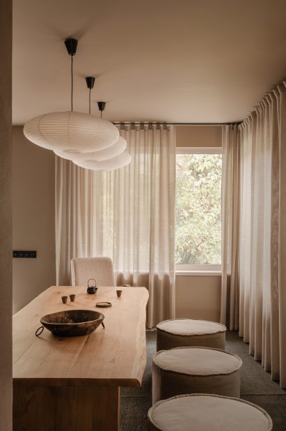 Tea room with long wooden table inside wellness centre in Kyiv by Olga Fradina