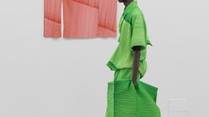 Model wearing all-green outfit from Issey Miyake Homme Plissé AW24 collection in collaboration with Ronan Bouroullec