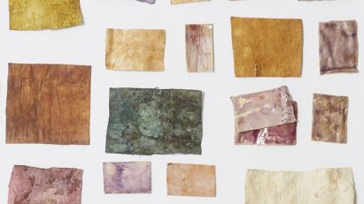 Photo of swatches of mycelium dyed in different deep colours