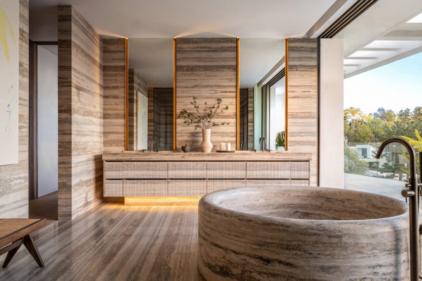 A bathroom made of stone with circular bath