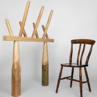 Photo of a traditional wooden chair on the right and an experimental column and beam structure topped by spindles on the left