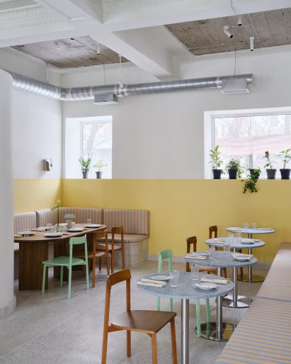 Yellow dado wall zone in FIKA Restaurant in Kazakhstan by NAAW Studio