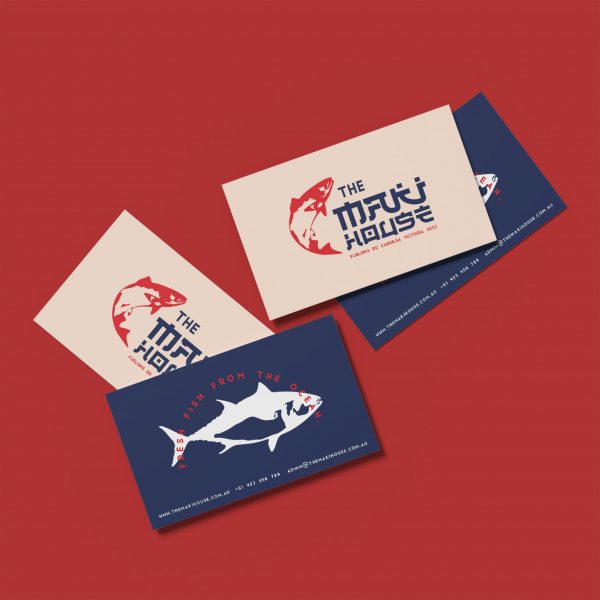 Business cards with fish on them on dark red background