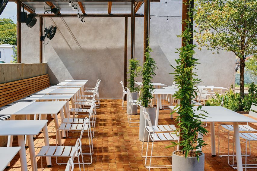 A patio with white metal seating