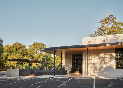 The exterior of a small, modern grocery store