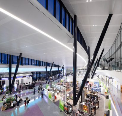 White terminal inside red Boston Logan airport building