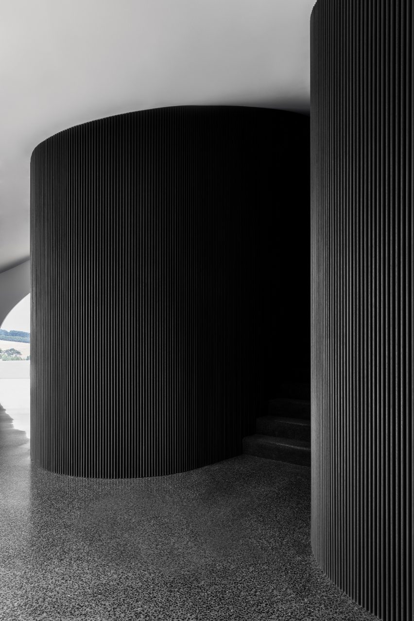 Curving staircase with charred timber walls