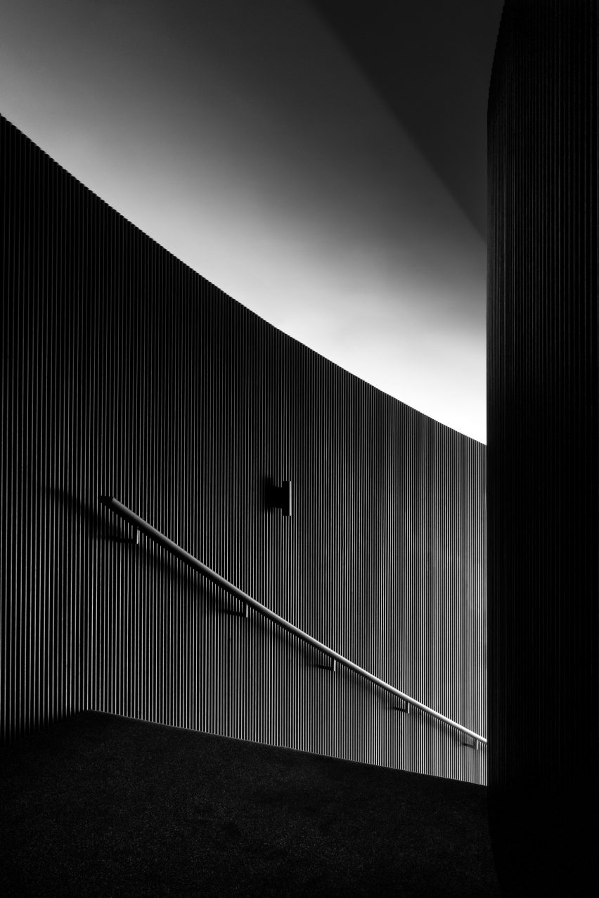 Staircase with black timber walls