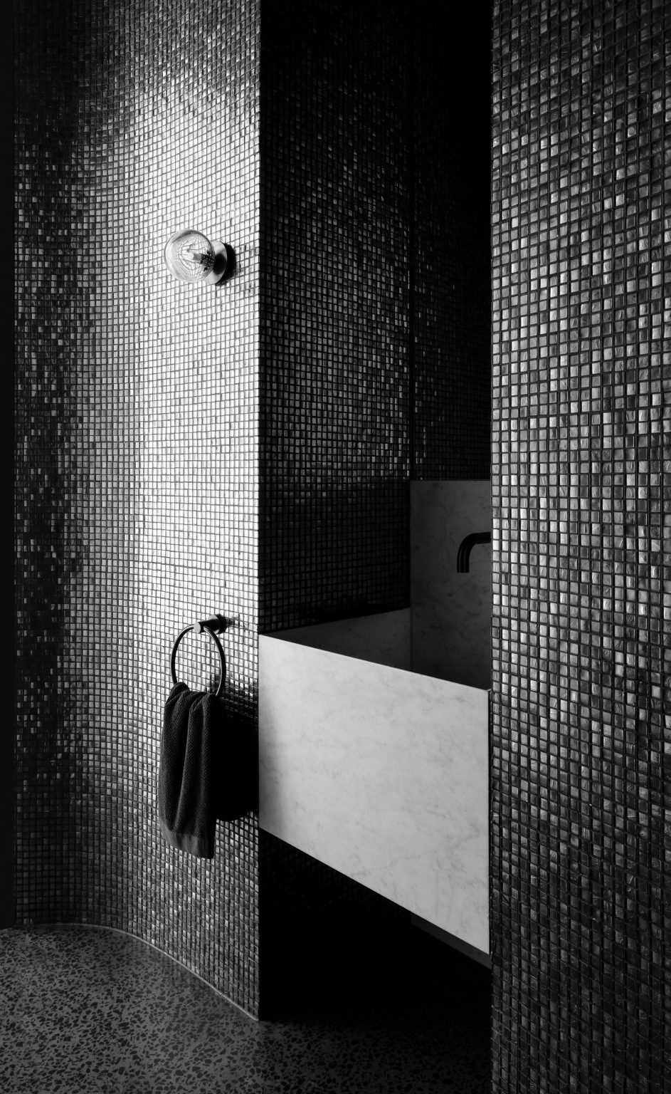 Black mosaic-tiled bathroom