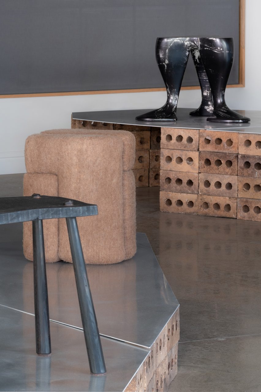 Two black stools of different forms