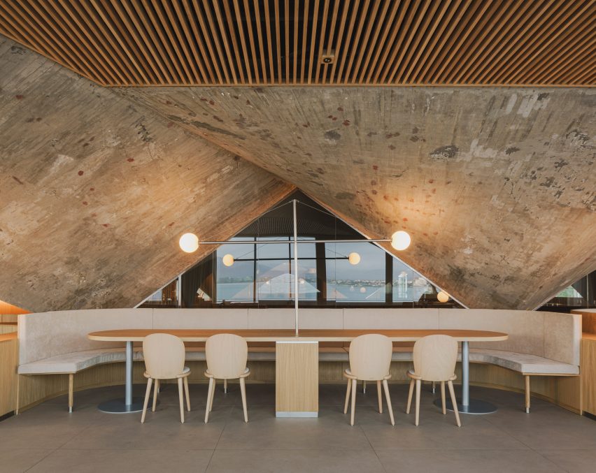 Concrete paraboloid and dining tables inside brutalist restaurant in Spain by Zooco Estudio