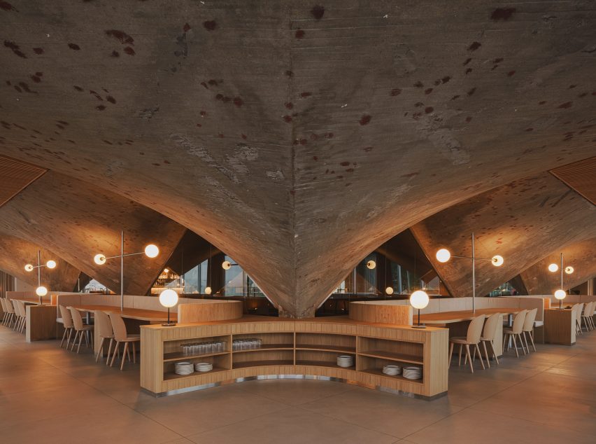Concrete paraboloid and storage cabinet inside brutalist restaurant in Spain by Zooco Estudio