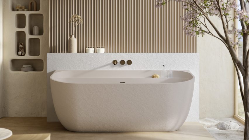 Photo of a large, pale pink built-in bathtub in a luxurious bathroom