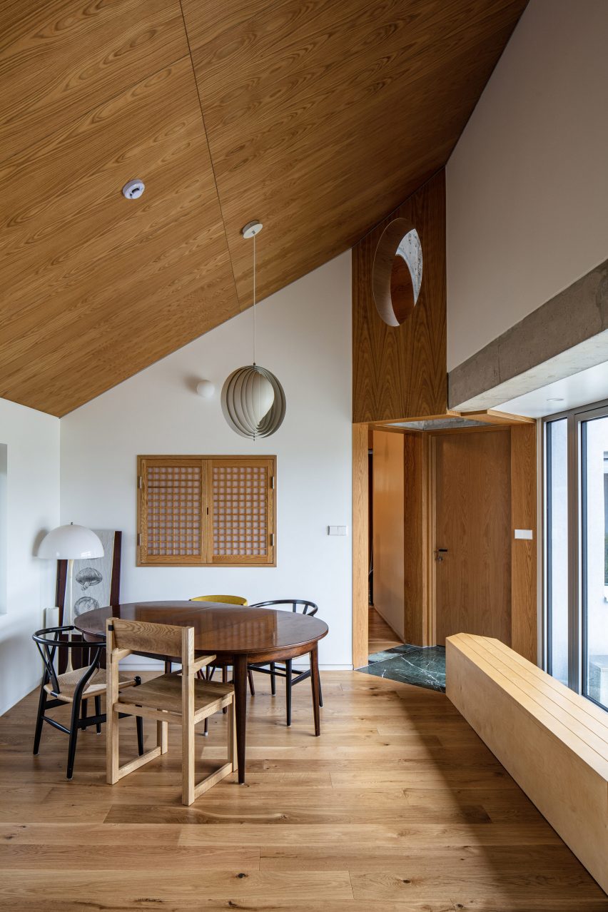 Dining room with a pitched roof and timber ceiling and floors