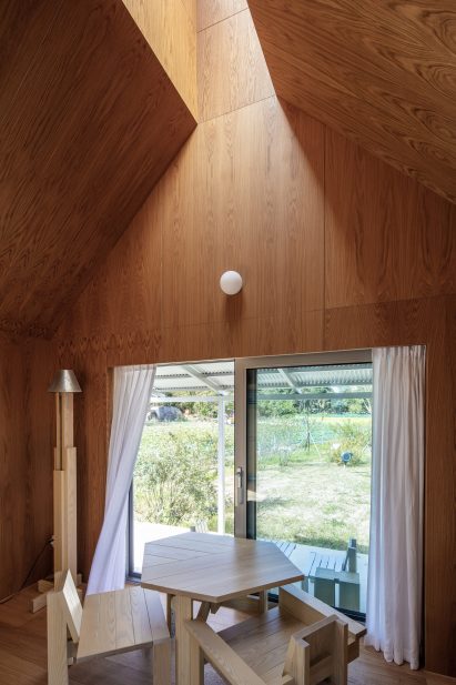 Concrete home interior with a pitched roof and light well
