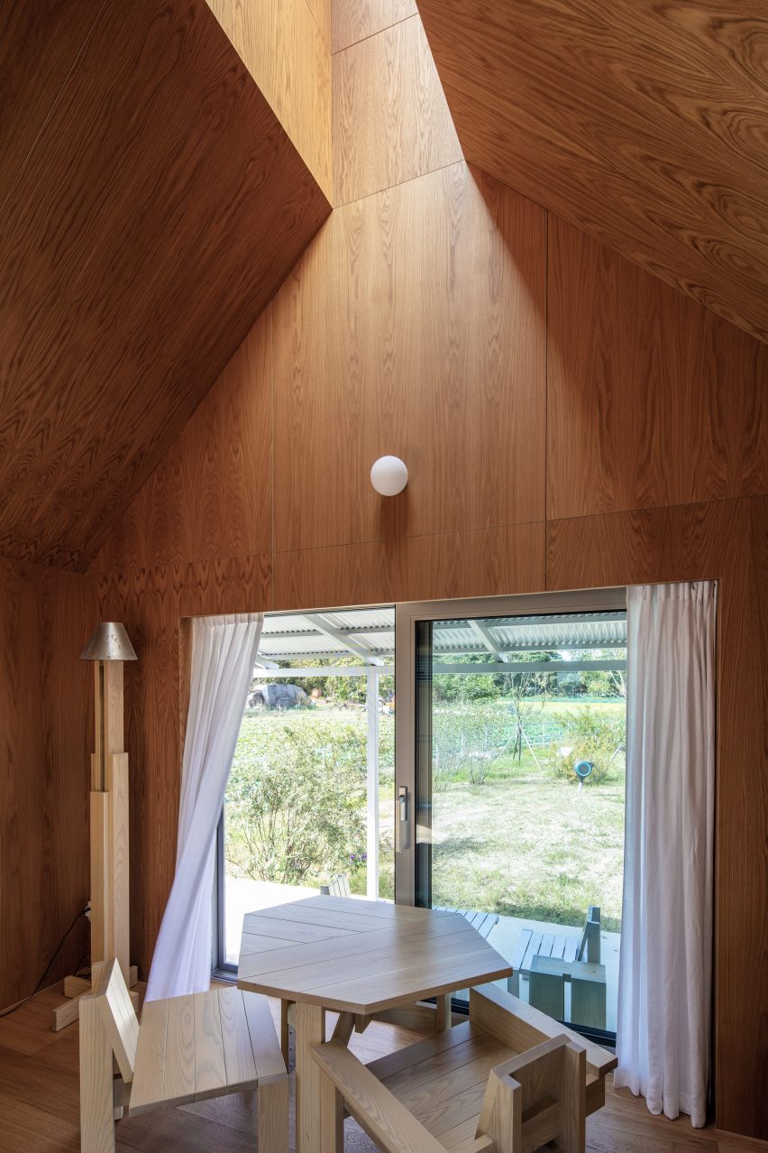 Concrete home interior with a pitched roof and light well