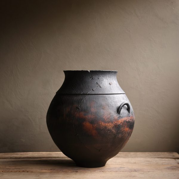 A large wooden vessel with a mended crack