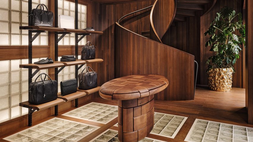 Walnut table infront of spiral staircase