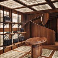 Walnut table and spiral staircase at Bottega Veneta store