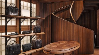 Walnut table and spiral staircase at Bottega Veneta store