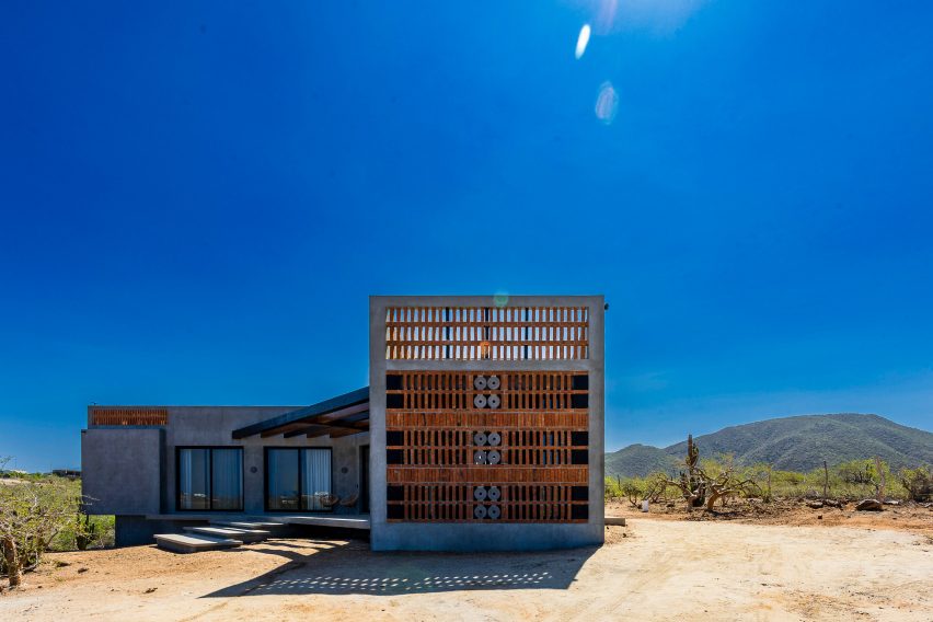Concrete home with wooden gate