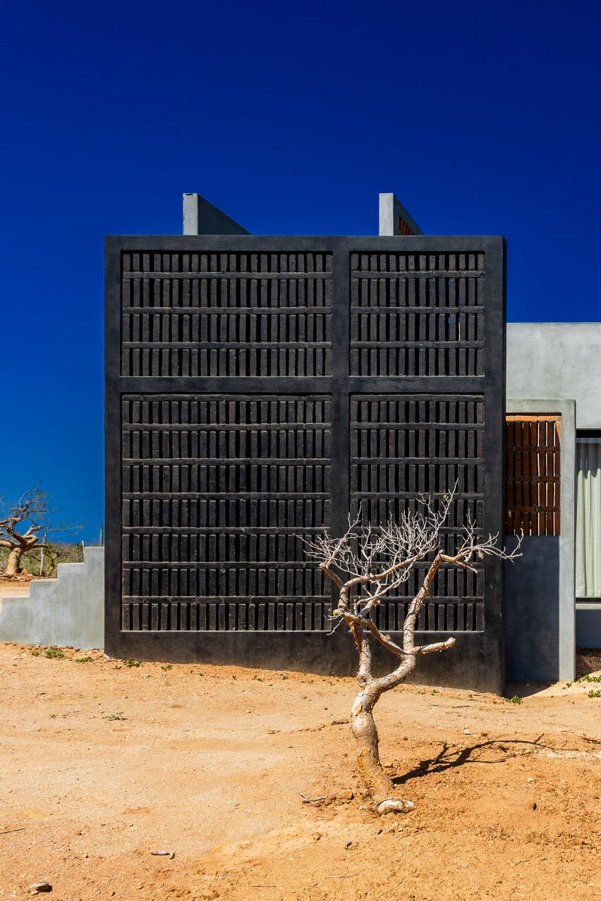 Concrete home with wooden gate