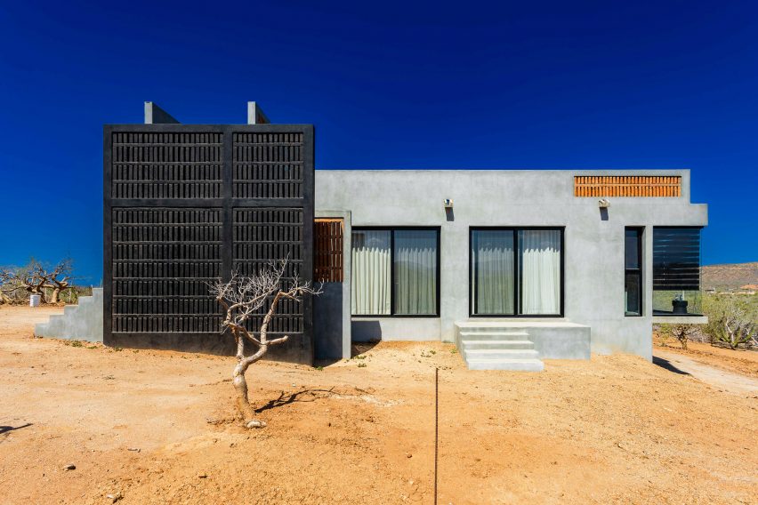 Concrete home with wooden gate