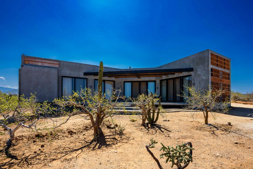 Concrete home with wooden gate