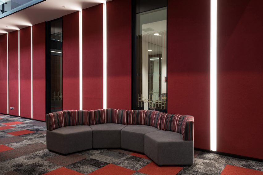 Dark red Composition acoustic wall coverings by Autex in school