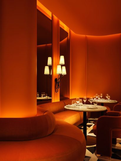 Burnt orange dining area with a wavy banquette