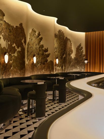 Bar with wavy walls and green banquette