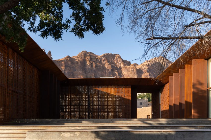 Photo of the internal courtyard of Design Space AlUla in Saudi Arabia showing desert hills rising in the background beyond the building's roofline