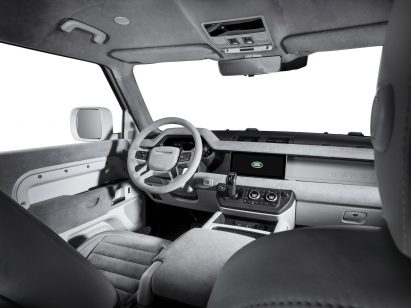 Image of the interior of the Firmship Land Rover Defender showing monochrome light grey finishing including leather and fabric seats with horizontal ribbing