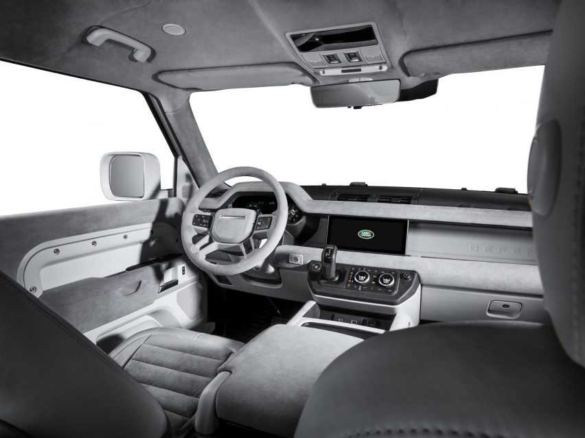 Image of the interior of the Firmship Land Rover Defender showing monochrome light grey finishing including leather and fabric seats with horizontal ribbing