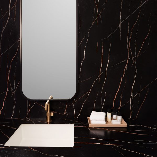 Dark surface by Formica Corporation covering bathroom counter
