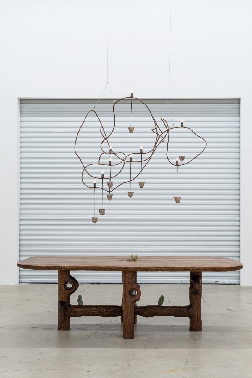 A wiggly lamp hanging over table