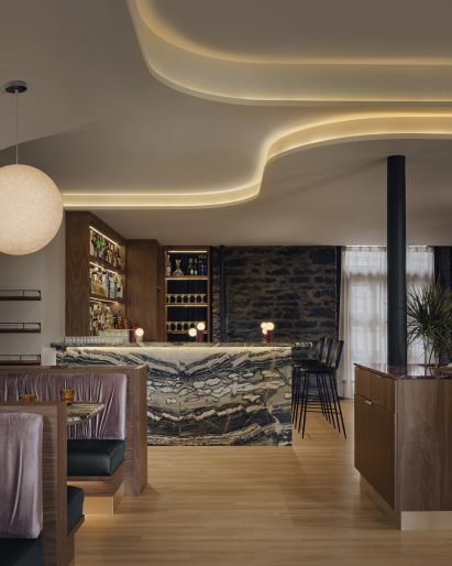 The bar counter made from teal, pistachio and cream-coloured marble