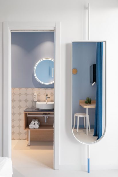 Bathroom and mirror inside hotel in Italy by Fiorini D'Amico Architetti (FDA)