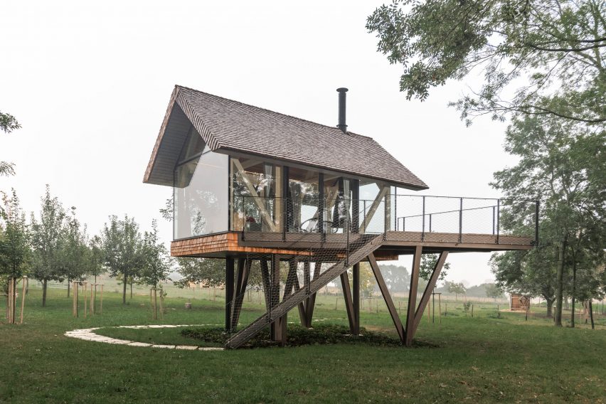 Exterior of glass micro house on stilts by Jan Tyrpekl in Austria