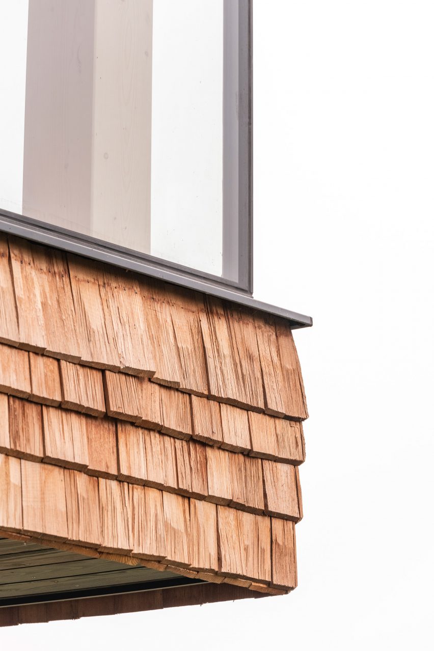 Close up of shingle cladding on glass micro house on stilts by Jan Tyrpekl in Austria